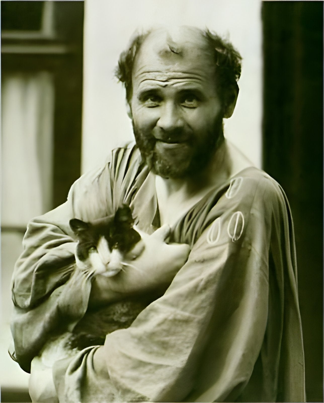 Photograph of Gustav Klimt holding a cat.